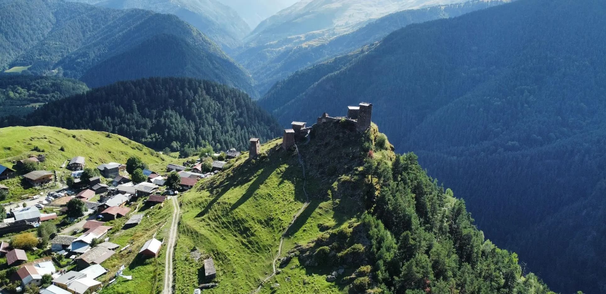 Remote Georgian mountain village beneath a hilltop fortress