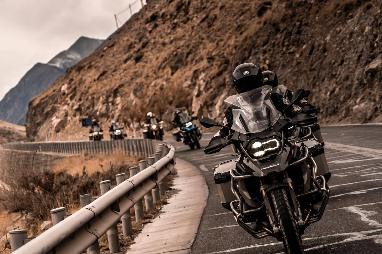 Motorcyclists riding through the high-altitude landscape of Tibet